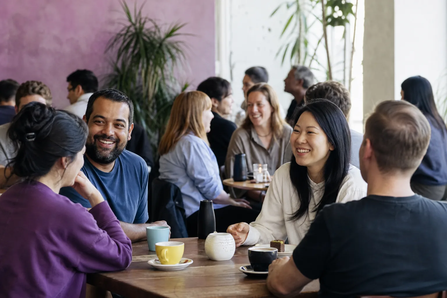 Two people talking at a relaxed social event in Norwich