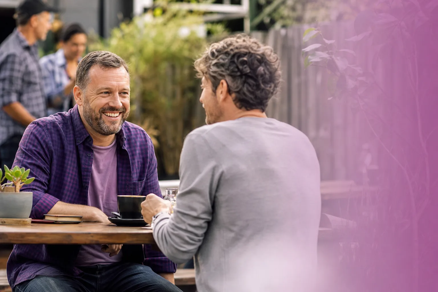 Two men talking over coffee in central Norwich