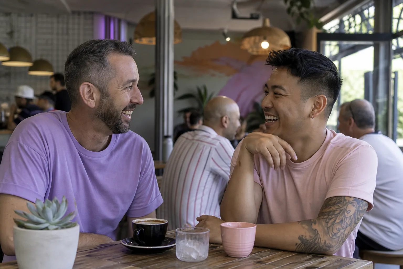 Two men chatting over coffee in Norwich city centre